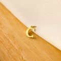 Detailed view of a gold letter C pendant on a natural wood and white linen background - 14k Letter - C (letter Height 1cm)