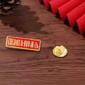 Detail of I Love China enamel pin with butterfly clutch on a rustic wooden background - I Love China