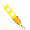 Detail of yellow floral handbag strap with golden metal clasp and leather reinforcement - Yellow Flowers + Yellow Leather