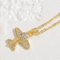 Macro shot of a gold airplane pendant with shimmering zircon pavé on a fine chain - Gold Airplane