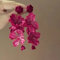 Close-up of elegant long floral drop earrings with red fabric petals and pearl stamen - Red Rose Flower Style (20#)