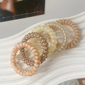 Set of 6 jelly color hair coils in beige and checkered patterns on a wavy tray - Beige Series