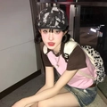 Close-up of a vintage black and white checkered beret hat with stylish casual outfit - Black Washed Denim Distressed