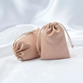 Elegant satin drawstring jewelry pouch in soft nude pink with premium silk texture - Peach