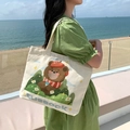 Beige canvas tote bag with cartoon bear illustration and tussock text for daily use - Flower Gazing Bear
