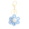 Blue knitted daisy flower keychain with white pearl center and golden metal clasp - Style 10 Light Blue