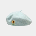 Detail of light blue wool beret featuring intricate yellow sunflower embroidery - One Size / Light Blue