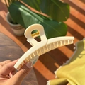 Detail of high-elasticity golden metal spring on large cream matte butterfly hair claw - Solid White