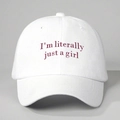 Detailed close-up of embroidered red lettering on a white cotton baseball cap - White