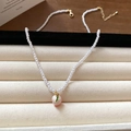 Long faux pearl necklace with a pink peach pendant and gold chain on beige display - Pink Peach Pendant (95#)