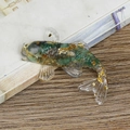 Transparent resin fish figurine with green pigment and gold foil flakes detail - South African Green Stone