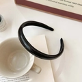 Minimalist black faux leather headband on a white ceramic cup with a vintage book - Black-Plain