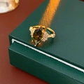 Detailed macro view of vintage gold ring with marquise cut emerald green stone - Green Marquise Adjustable Open Ring