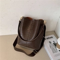 Brown crocodile-embossed bucket bag with wide fabric strap and gold hardware accents - Coffee