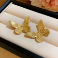 Elegant gold butterfly stud earrings with polka dot texture on a beige cushion - 3D Gold Butterfly Studs (5# Silver Pin)