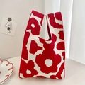 Close-up of knit tote bag featuring red floral Unikko pattern on a minimalist table - Red Full Flower