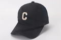 Side view of black cotton baseball cap with white letter C embroidery and curved brim - Kids (2-8 Years) / C Letter Black