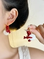 Detail of long tassel earrings with red crushed stones and white shell charms on model - Beaded Shell Earrings / White Red and Gold