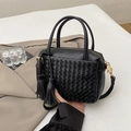 Handwoven black square handbag with dual handles, fringe charms and golden hardware - Black