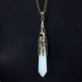 Close-up of hexagonal opal pendant with vintage bronze filigree cap on a black background - Antique Bronze + Opal