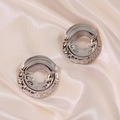 Polished silver titanium steel hoop earrings with hammered texture on satin background - Silver