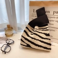 Knitted bucket bag featuring a black and white zebra pattern with a knotted handle design - Black Beige Zebra
