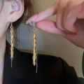 Close-up of golden leaf tassel earrings with fish-hook wires on a female model - Leaf Sheet Chain Tassel (5#)