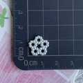 Detailed view of white pearl flower bead showing hollow design and 1.2cm size measurement - Flower
