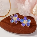 Elegant cherry blossom earrings in iridescent purple with yellow floral centers - Iridescent Purple Cherry Blossom Resin Earrings