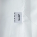 Detail shot of the care label showing 95% polyester and 5% spandex fabric composition - S / White