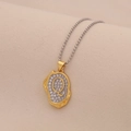 Macro view of gold letter Q pendant with cubic zirconia on elegant ball chain - Letter Q