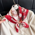 Elegant red and beige floral square scarf tied on a beige blazer with a camellia brooch - 90 Square Scarves / 65