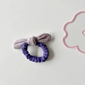 Detail view of a dual-tone purple suede bow hair tie with soft textured fabric - Pink Bow
