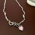 Detailed shot of silver wave chain with pink heart pendant and colorful zircon stones - Heart Necklace Style One
