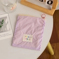 Detail of purple nylon cosmetic pouch featuring a yellow zipper and pink ring puller - Light Purple (Vertical)