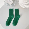 Solid green cotton ribbed mid-calf socks in Japanese minimalist style on white table - Vintage Green