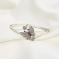 Detailed close-up of a silver butterfly bangle with pink and white pavé rhinestones - Silver