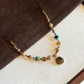 Detailed view of beaded necklace with tiger eye stone pendant and mixed earth tone beads - Gold Handmade Mixed Beaded (36#)