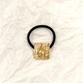 Black elastic hair tie featuring a hollow square gold-tone metal piece with textured finish - Gold Square 2.5cm