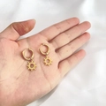 Detailed close-up of 18K gold-plated starburst earrings held in hand for scale - Sun Shape (DE064)