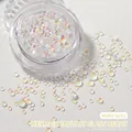 Close-up of mixed size aurora mermaid glass beads for nail art in a clear round container - Mocha White