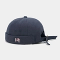 Detail of navy blue brimless docker hat featuring white 'lit' embroidery and metal buckle - Slate Gray