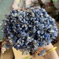 Handmade crystal tree crafted with blue and grey stones and copper wire on a palm - Blue Aventurine