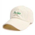 Close-up of New York embroidery and distressed ripped details on off-white cotton baseball cap - Beige