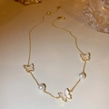 Golden chain necklace with white butterfly pendant and pearls on a light surface - 36# Necklace - Real Gold - Golden