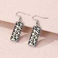 Silver-tone rectangular leopard print earrings displayed on a pink textured background - Fashion Leopard Design (FXEH-27-13)
