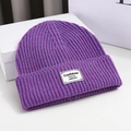 Detailed close-up of purple knit beanie with vertical texture and stylish label - 56-58cm / Purple