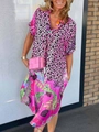 Close-up of pink leopard and tropical floral print dress with a pink woven handbag - Pink