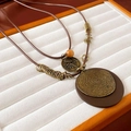 Detail of bohemian long necklace featuring layered metal rings and brown wooden beads - Brown Disc