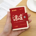 Red and beige leather card holder with snap closure and lucky cat coin pattern design - 24 Slots / RFID Abundant Wealth